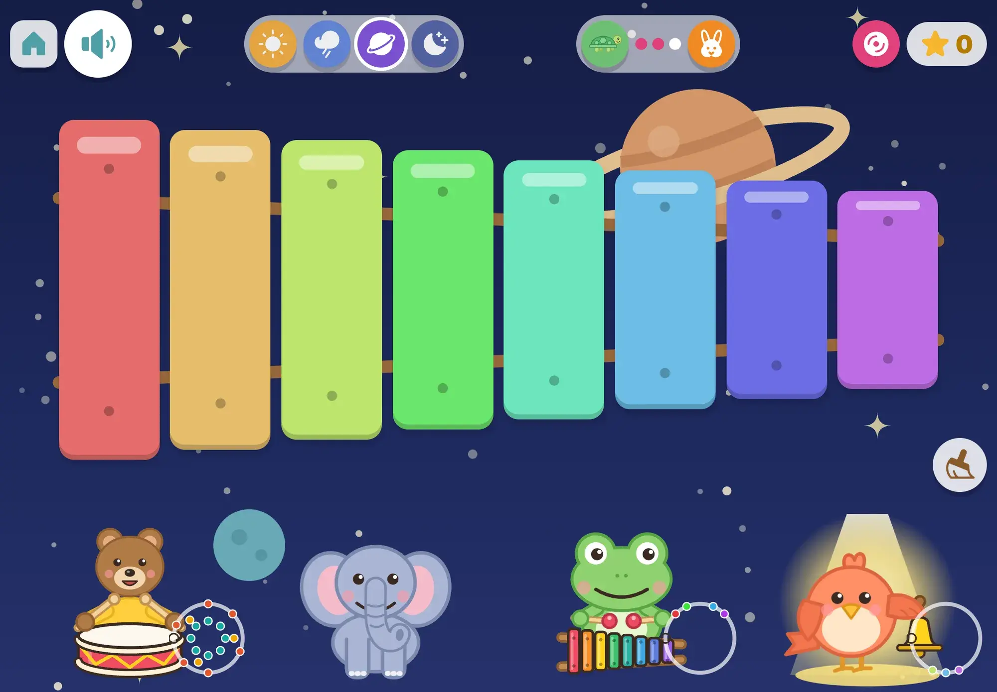 In the space mood, under a ringed planet and stars, the frog's rainbow xylophone fills the screen while the bird rings its bell in a spotlight
